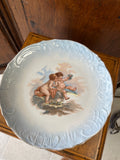 Decorative porcelain plate featuring cherubs