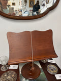 Vintage wooden pedestal bookstand with a turned base and fluted stem.