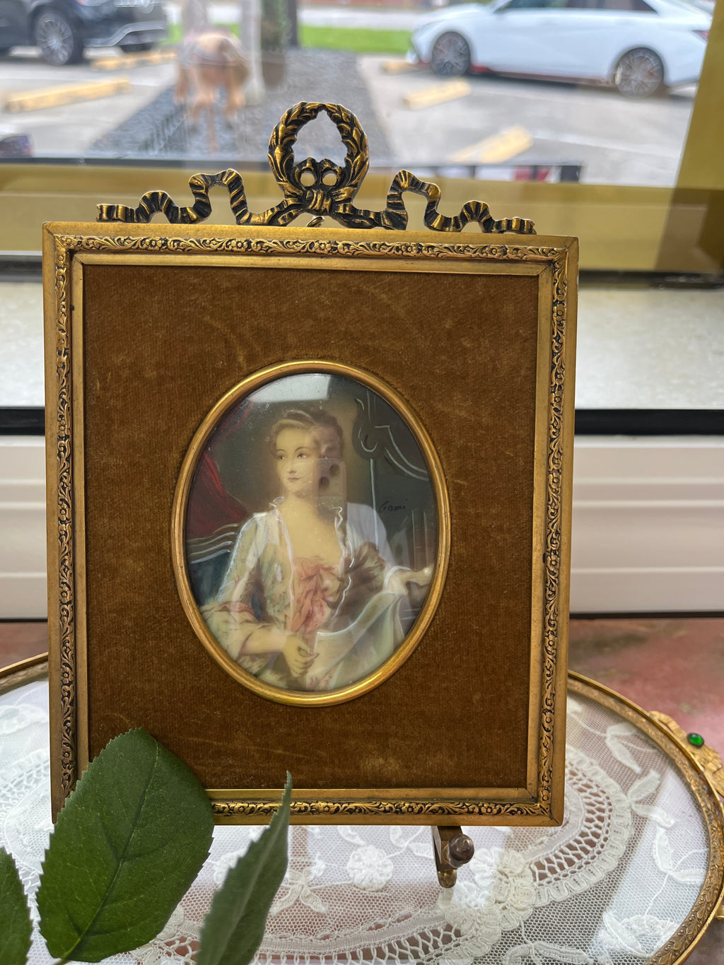 Hand-painted 18th-century miniature portrait of a woman, signed 'Gomi'.