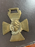 A Victorian horse brass featuring a relief of Queen Victoria.