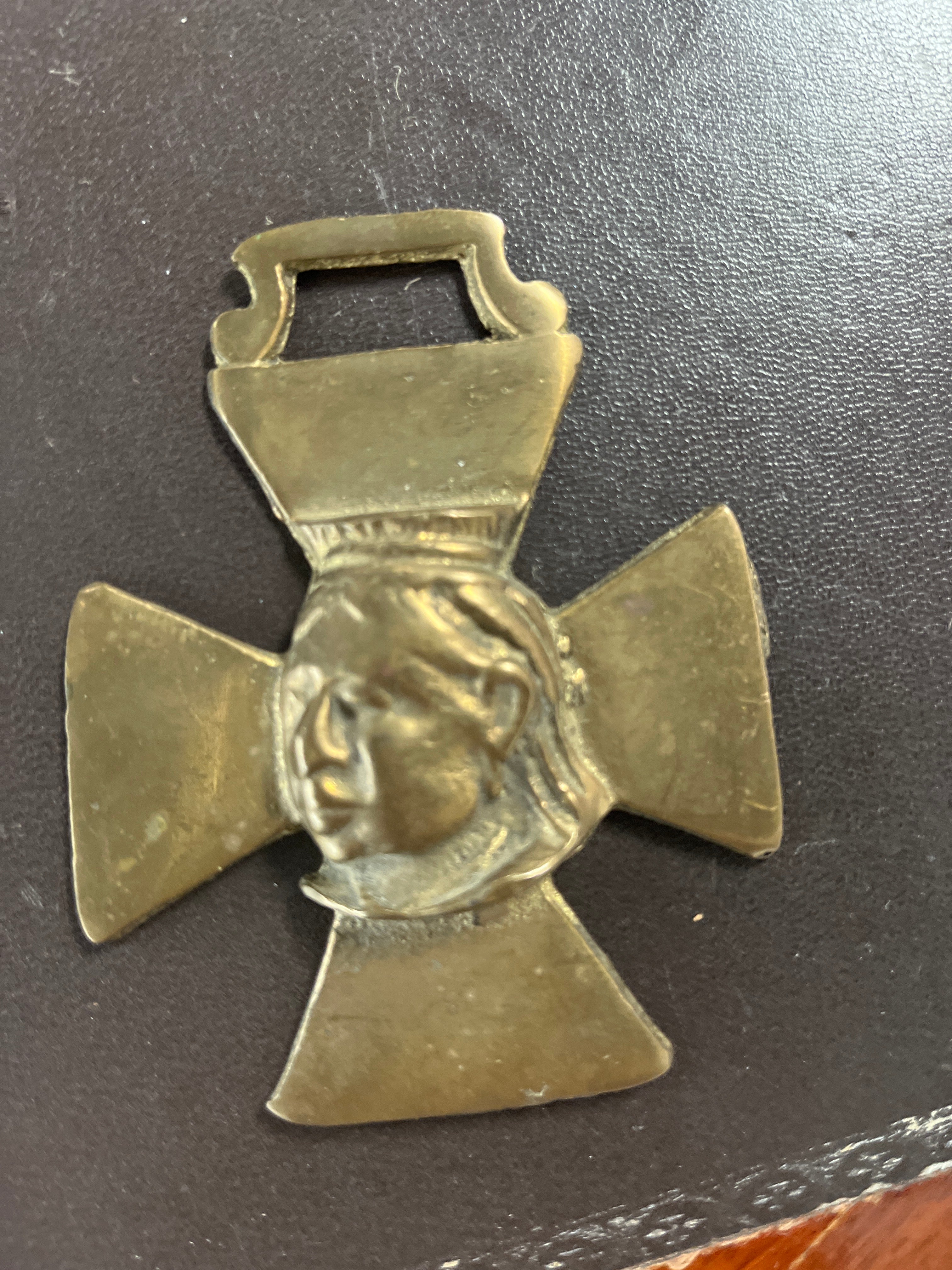 A Victorian horse brass featuring a relief of Queen Victoria.
